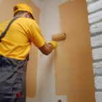 worker-painting-wall-with-paint-roller-2021-09-23-03-00-18-utc-scaled-e1638997168906